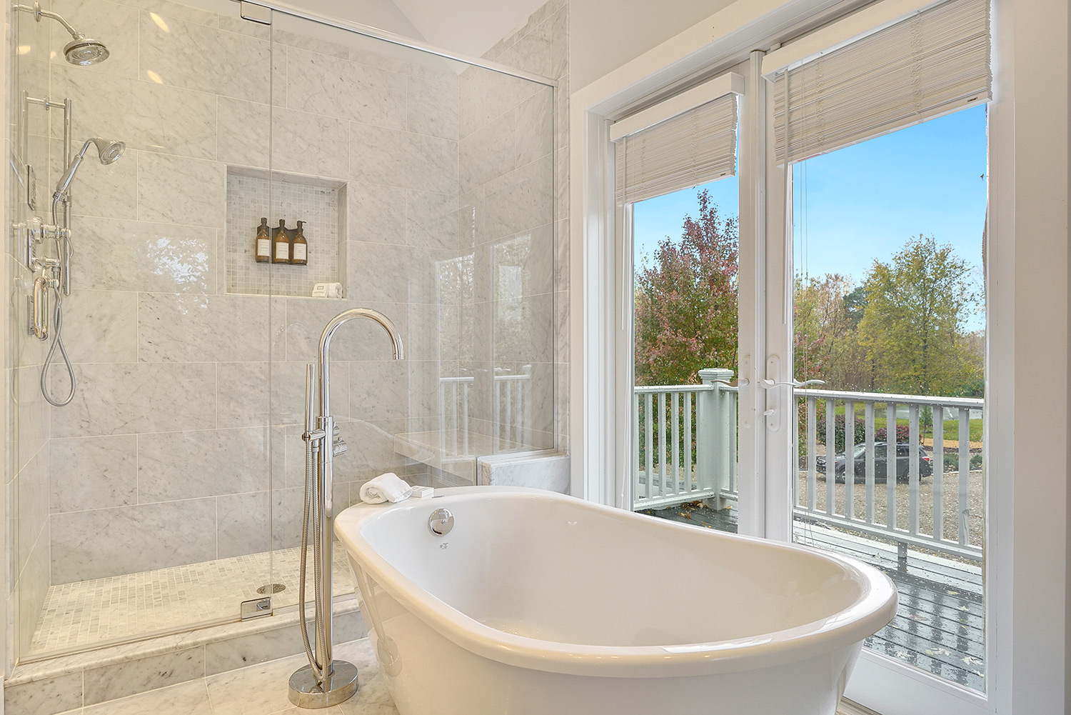 bathroom with shower tub and large windows