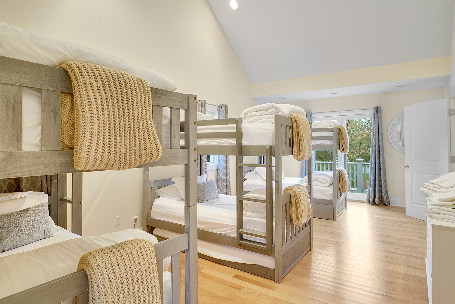 large room with three bunk beds